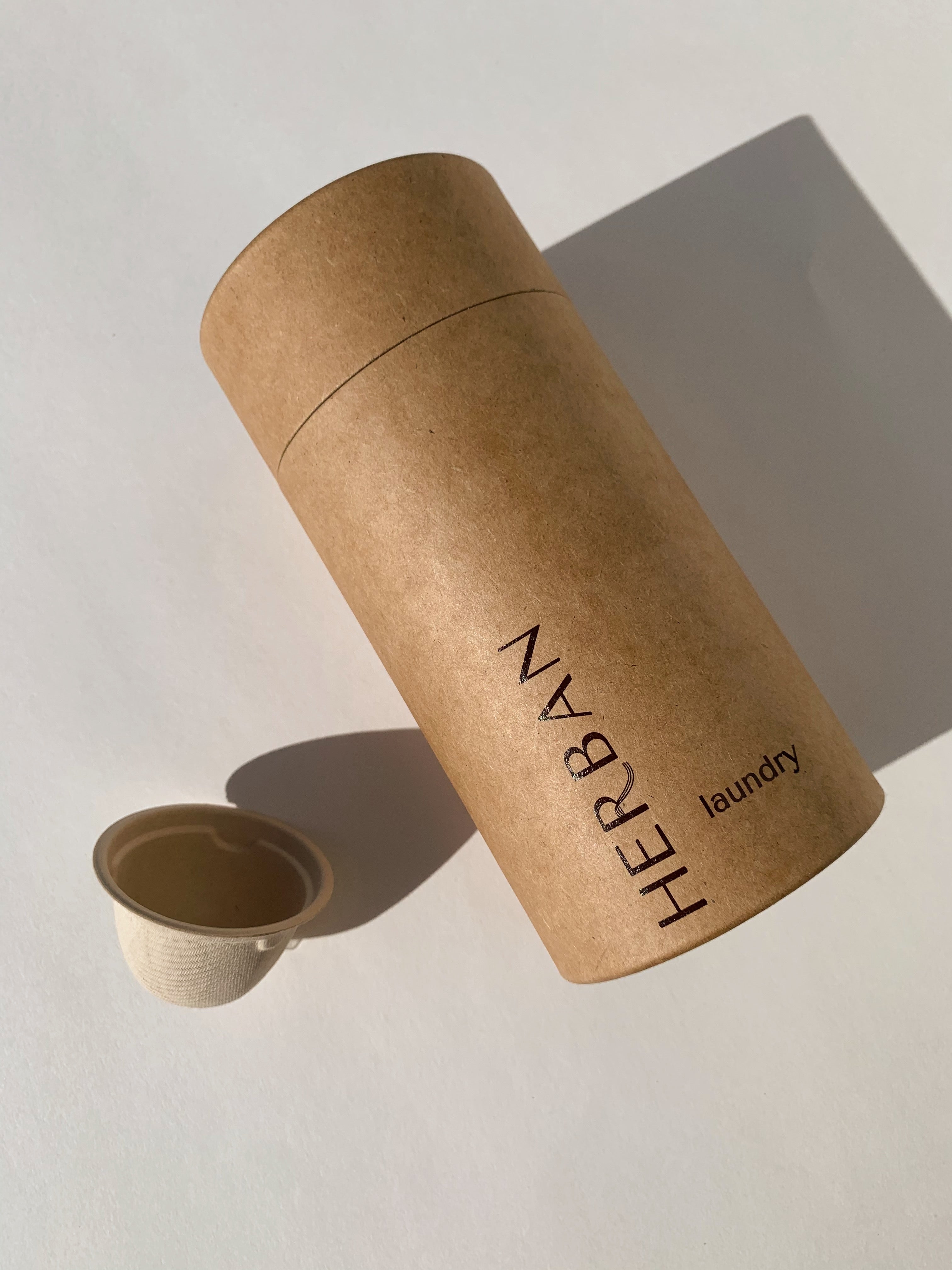 Kraft paper tube imprinted with Herban Laundry