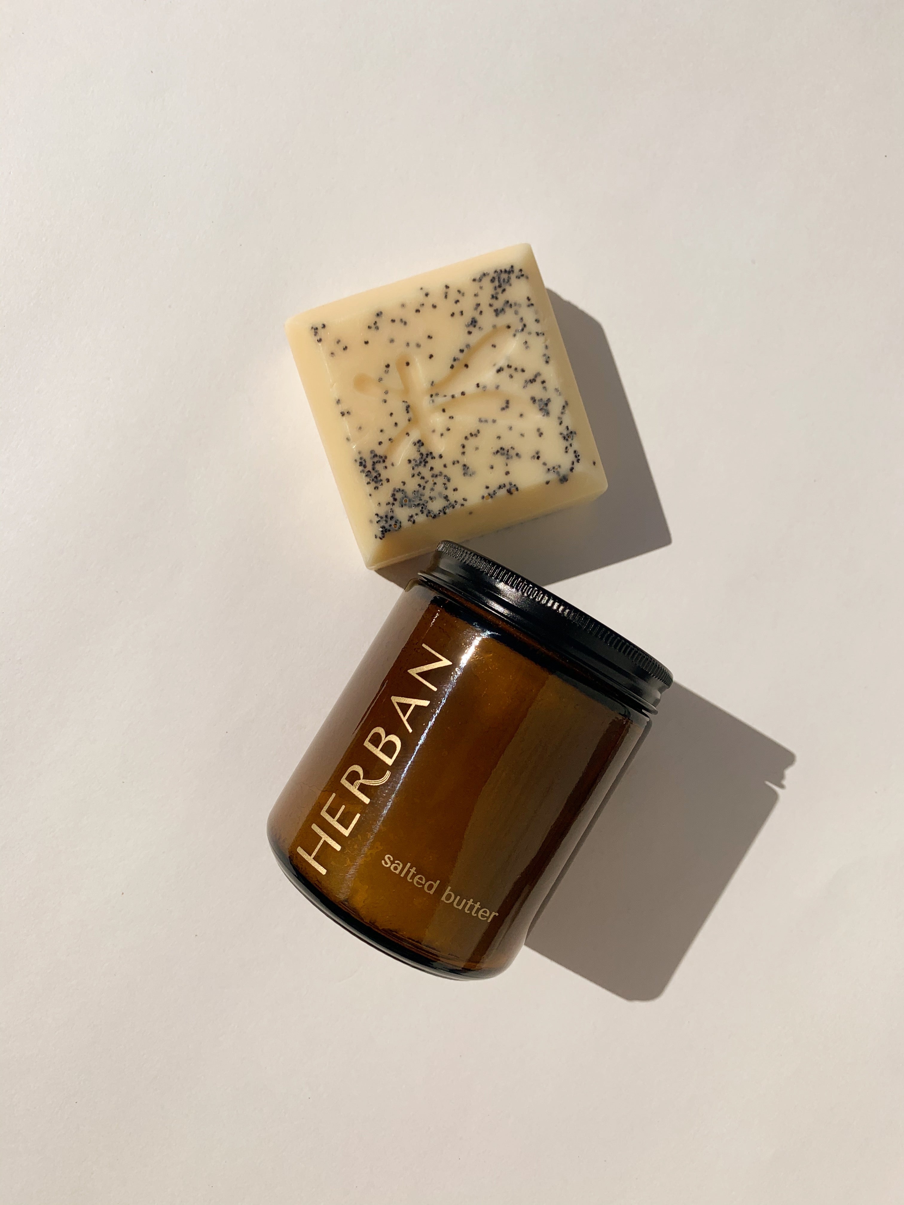 Herban Body Care Best Sellers include our signature humectant and herbal soap bar and our amber glass packaged, hydrating shea butter and sea salt body scrub!